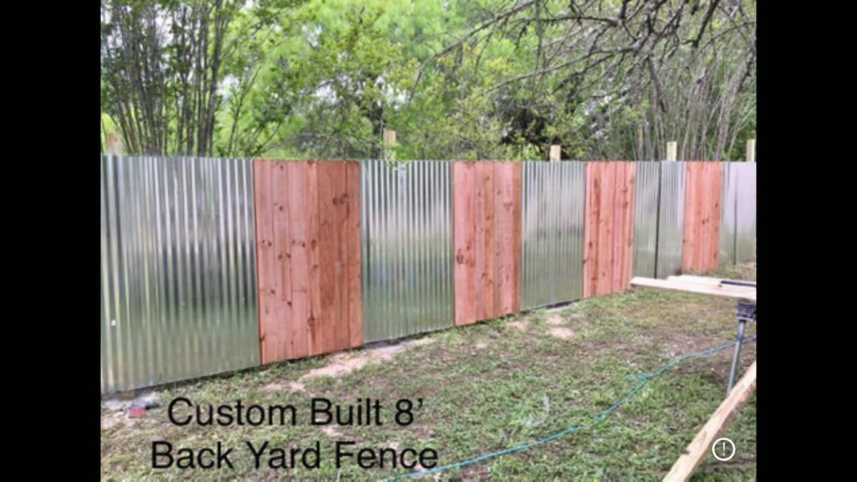 Custom backyard fence with alternating wood panel sections