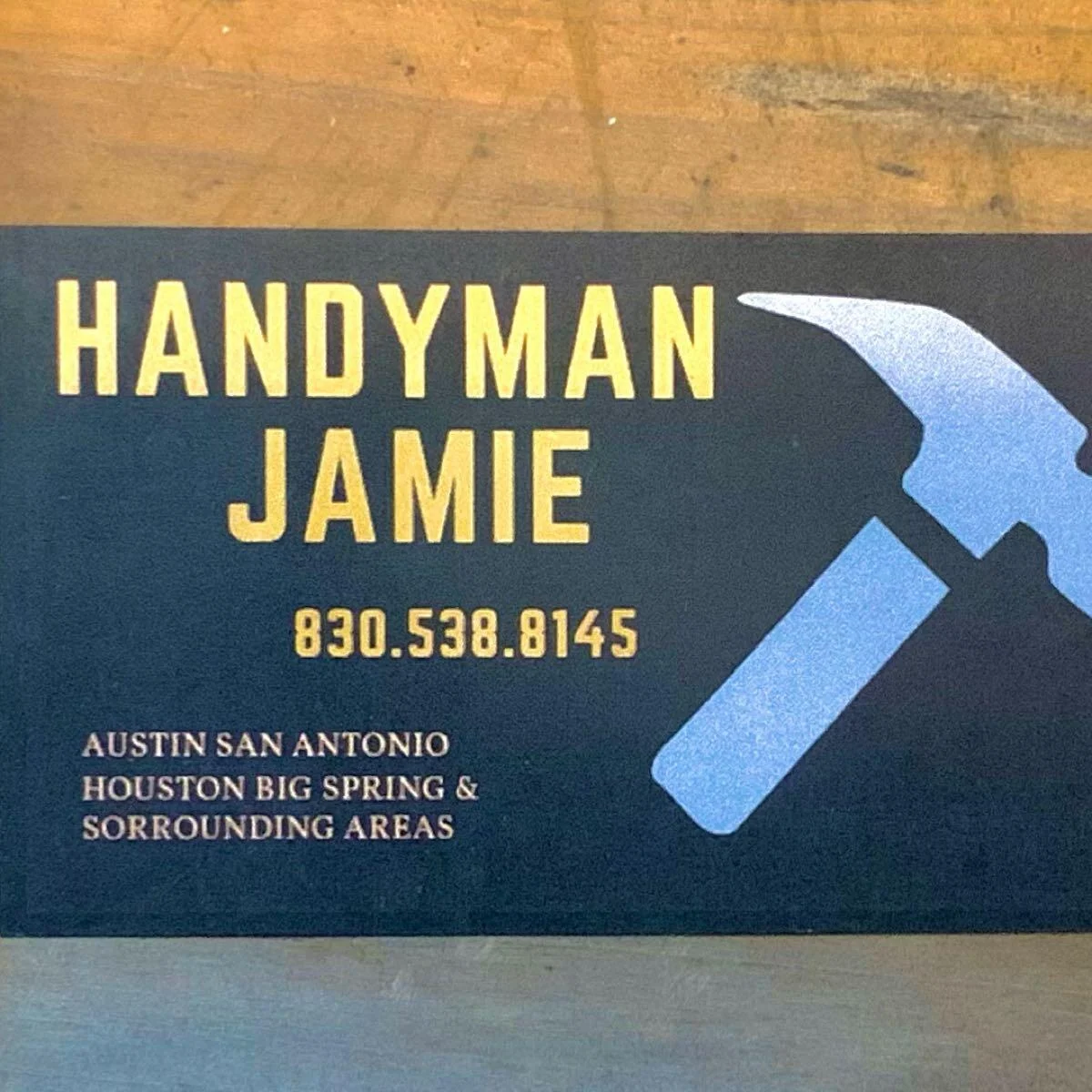 Handyman Jamie's business sign with hammer logo and phone number 830-538-8145