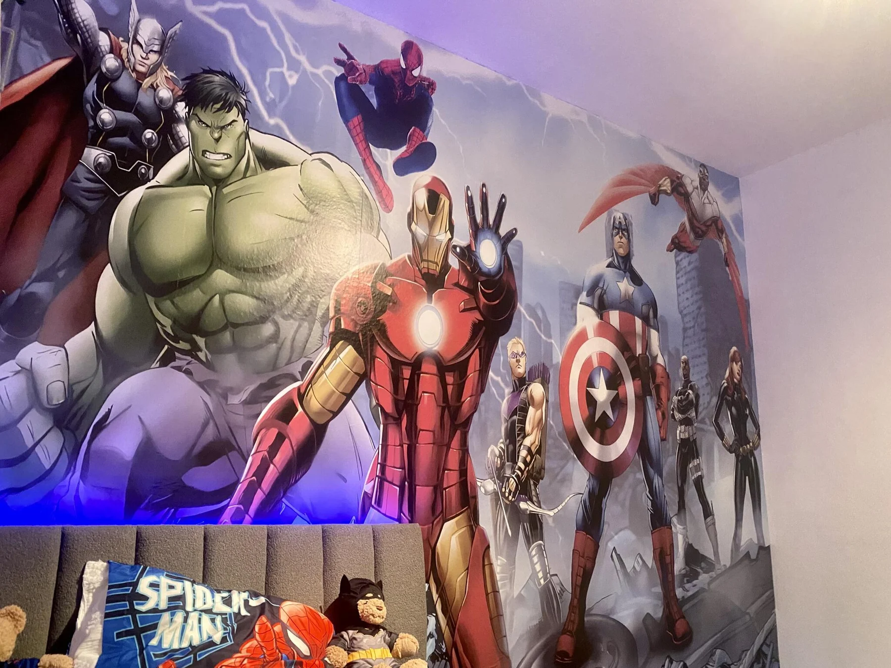Closer view of the superhero wallpaper across the room wall